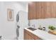 Laundry area featuring stacked washer and dryer, stylish cabinets, and a sink with modern fixtures at 603 Tremont St, Sarasota, FL 34242