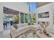 Bright and open living room with a modern fireplace, comfortable sectional sofa, and large windows offering natural light at 603 Tremont St, Sarasota, FL 34242