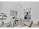 Stylish office space with a modern white desk, unique light fixture, and comfortable seating, perfect for a home office at 603 Tremont St, Sarasota, FL 34242