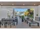 Outdoor space with sleek gray furniture, dining set, spiral staircase, and views of the backyard and pool area at 603 Tremont St, Sarasota, FL 34242