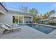 Backyard with a pool, spa, and outdoor lounge area for relaxing and entertaining at 603 Tremont St, Sarasota, FL 34242