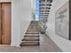 Contemporary floating staircase with wooden steps, complemented by minimalist decor and natural light at 603 Tremont St, Sarasota, FL 34242