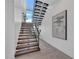Modern staircase features wood treads, glass accents, large windows, and stylish artwork at 603 Tremont St, Sarasota, FL 34242