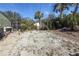 Backyard area featuring a gravel space, trees, and partial fence. Ready for custom landscaping at 6202 32Nd Avenue W Cir, Bradenton, FL 34209