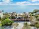 Waterfront condo building with tile roof, lush landscaping and beautiful bay views at 6430 Sun Eagle Ln # 103, Bradenton, FL 34210