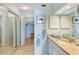 Fresh bathroom with a mirrored closet, granite countertop, and access to the walk-in closet at 6430 Sun Eagle Ln # 103, Bradenton, FL 34210