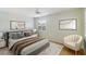 Bright bedroom features neutral walls, a ceiling fan, a window with shutters, and a cozy queen-sized bed at 6430 Sun Eagle Ln # 103, Bradenton, FL 34210