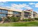 Condominium exterior view with multi-story facade, balconies, and lush landscaping, perfect for relaxing outdoor living at 6430 Sun Eagle Ln # 103, Bradenton, FL 34210