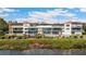 Beautiful waterfront condo building with lush landscaping and breathtaking views of the bay at 6430 Sun Eagle Ln # 103, Bradenton, FL 34210