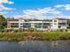 Beautiful waterfront condo building with lush landscaping and breathtaking views of the bay at 6430 Sun Eagle Ln # 103, Bradenton, FL 34210