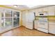 Bright kitchen with white appliances and a breakfast nook area near a window to the lanai at 6430 Sun Eagle Ln # 103, Bradenton, FL 34210
