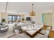 Open-concept living and dining area with serene water view from the sliding doors to the balcony at 6430 Sun Eagle Ln # 103, Bradenton, FL 34210