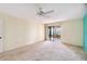 Bright and airy bedroom with soft carpet, a ceiling fan, and a sliding door to the lanai with water views at 6430 Sun Eagle Ln # 103, Bradenton, FL 34210