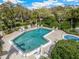 Community pool area featuring a swimming pool, lounge chairs, and jacuzzi tub at 6430 Sun Eagle Ln # 103, Bradenton, FL 34210