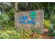 Entrance sign to community, surrounded by vibrant flowers and lush landscaping at 6430 Sun Eagle Ln # 103, Bradenton, FL 34210