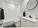 Modern bathroom featuring all-white tiled shower and vanity with black hardware at 701 37Th Avenue E Dr, Bradenton, FL 34208