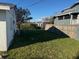 A beautiful backyard features a lush green lawn and mature trees at 704 Chippy Ln, Nokomis, FL 34275