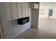 View into the kitchen area from the open floor plan, showcasing essential appliances at 704 Chippy Ln, Nokomis, FL 34275