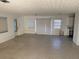 Spacious living room with three windows and laminate floors at 704 Chippy Ln, Nokomis, FL 34275
