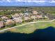 Aerial view highlighting a home near a lake, showcasing its screened lanai and surrounding community at 7052 Woodmore Ter, Lakewood Ranch, FL 34202