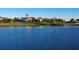 Exterior view of home on golf course in a lakeside setting with mature trees and landscaping at 7052 Woodmore Ter, Lakewood Ranch, FL 34202