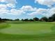 Picture of golf course green with a green and manicured fairways in the background at 7052 Woodmore Ter, Lakewood Ranch, FL 34202