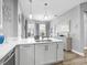 Kitchen island featuring a sink, stainless steel dishwasher and pendant lighting at 7052 Woodmore Ter, Lakewood Ranch, FL 34202