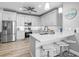 Stylish kitchen with stainless steel appliances, breakfast bar, and modern white cabinets at 7052 Woodmore Ter, Lakewood Ranch, FL 34202