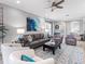 Bright and airy living room featuring a modern ceiling fan and comfortable seating arrangement at 7052 Woodmore Ter, Lakewood Ranch, FL 34202