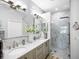 Gorgeous bathroom with double sinks, a marble shower and a glass enclosure at 7052 Woodmore Ter, Lakewood Ranch, FL 34202