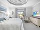 Beautiful bedroom featuring a trey ceiling, television and sitting area at 7052 Woodmore Ter, Lakewood Ranch, FL 34202