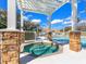 Inviting hot tub next to a pool with stone pillars, creating a luxurious outdoor space at 7052 Woodmore Ter, Lakewood Ranch, FL 34202