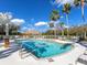 Refreshing community pool surrounded by palm trees and comfortable lounge chairs under a sunny sky at 7052 Woodmore Ter, Lakewood Ranch, FL 34202