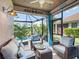 Relaxing sun room with comfortable seating and a view of the pool and lush landscaping at 7052 Woodmore Ter, Lakewood Ranch, FL 34202