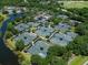 Aerial view of many tennis courts with lush greenery and a view of community pool at 7052 Woodmore Ter, Lakewood Ranch, FL 34202