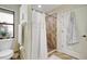 This bathroom features a tiled walk-in shower and an adjacent linen closet for storage at 7214 35Th E Ln, Sarasota, FL 34243