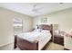 Comfortable bedroom with a wood bed, side table, and window for natural light at 7214 35Th E Ln, Sarasota, FL 34243