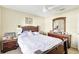 Warm bedroom with a wood bed frame, dresser, and soft lighting for a comforting feel at 7214 35Th E Ln, Sarasota, FL 34243