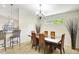 Formal dining room with modern decor and tan carpeting, open to the kitchen area at 7214 35Th E Ln, Sarasota, FL 34243