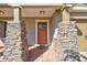 Inviting front entryway with a wood door and beautiful stone columns, welcoming you to this lovely home at 7214 35Th E Ln, Sarasota, FL 34243