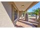 Covered front porch featuring stone columns and brick flooring, providing a cozy outdoor space at 7214 35Th E Ln, Sarasota, FL 34243