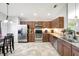 Well-equipped kitchen with stainless steel appliances, granite countertops, and wood cabinetry for ample storage at 7214 35Th E Ln, Sarasota, FL 34243
