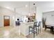 Open concept kitchen with a breakfast bar, seamlessly connecting to the dining and living areas for easy entertaining at 7214 35Th E Ln, Sarasota, FL 34243