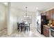 Cozy eat-in kitchen with tile floor, stainless steel refrigerator and dining table set at 7214 35Th E Ln, Sarasota, FL 34243
