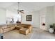 Cozy living room featuring a ceiling fan and large leather sectional, with an open concept design at 7214 35Th E Ln, Sarasota, FL 34243