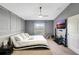 The stylish main bedroom is freshly painted in a modern shade of gray with crisp white trim at 7214 35Th E Ln, Sarasota, FL 34243