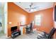 Inviting home office with orange accent wall, gaming chair, and functional workspace at 7214 35Th E Ln, Sarasota, FL 34243