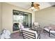 This covered patio features neutral furniture, brick flooring and a beautiful water view at 7214 35Th E Ln, Sarasota, FL 34243