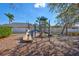 Community playground with slide, climbing features, and benches at 7214 35Th E Ln, Sarasota, FL 34243