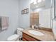 Bathroom features a granite countertop, framed mirror, and framed artwork at 7887 Limestone Ln # 12-102, Sarasota, FL 34233